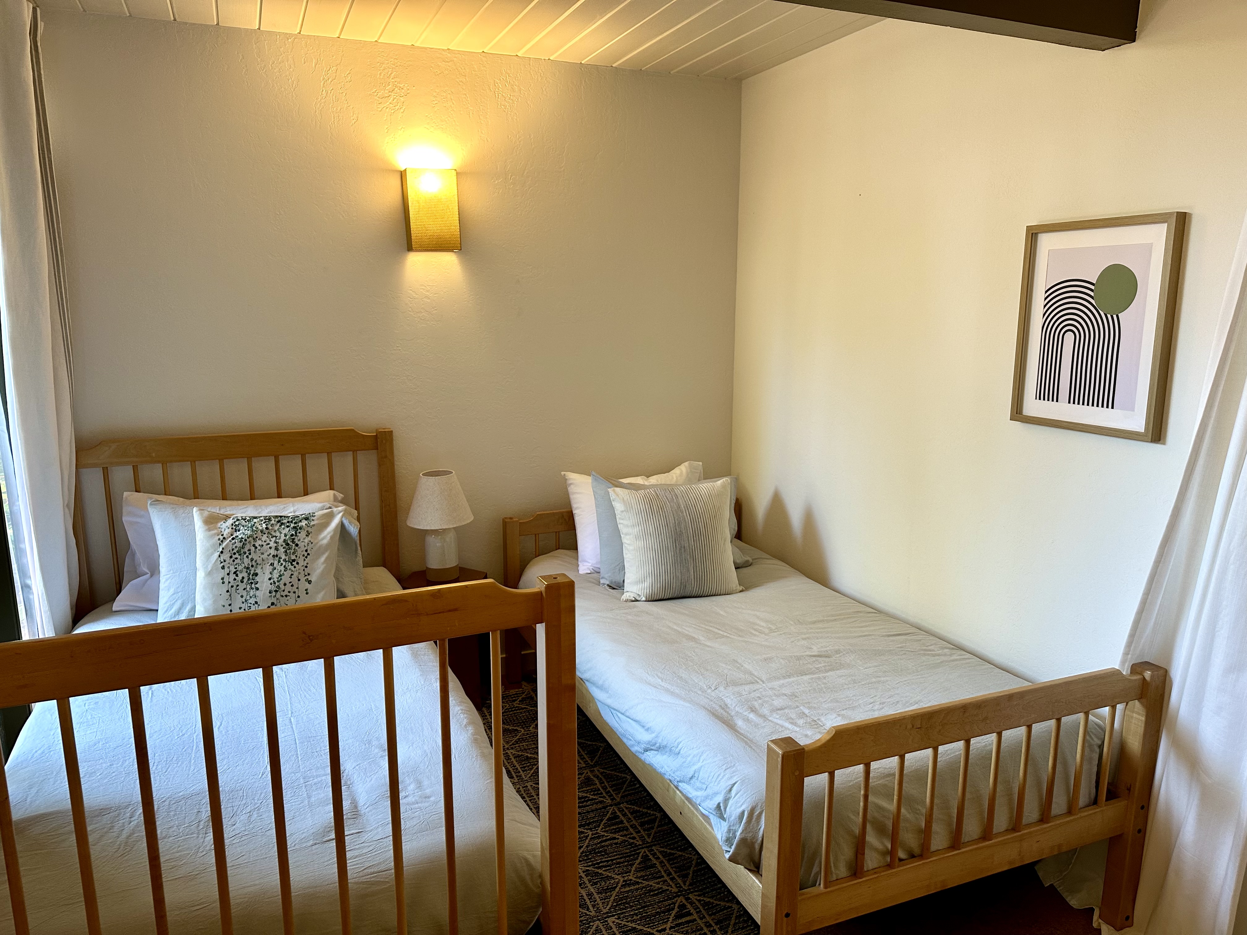 Bedroom four, with two twin beds separated by a curtain