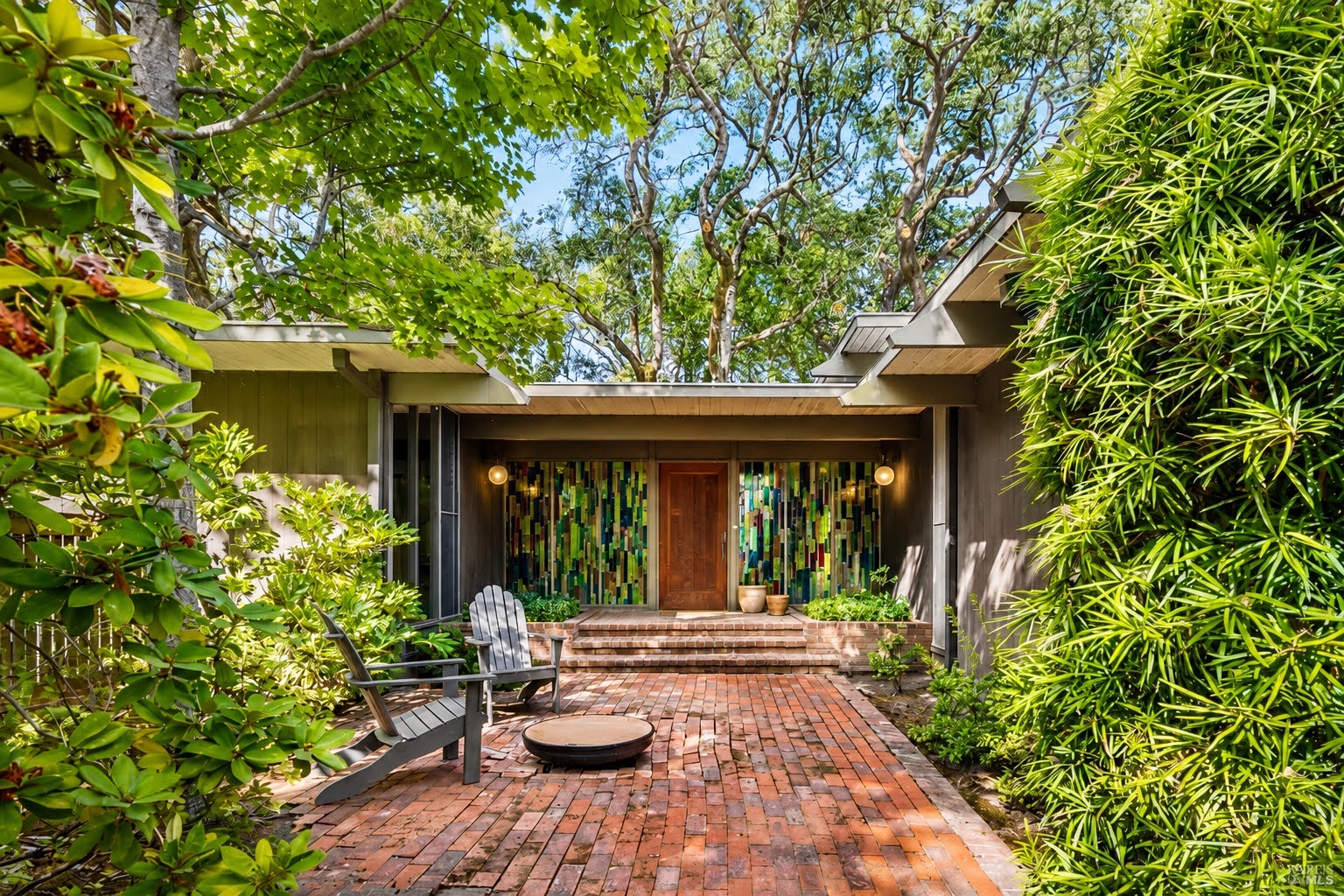 Stained-glass front entry, framed by trees